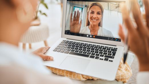 Laptop, video call and mental health with wave hello in virtual counseling consultation, doctor and patient in communication Psychologist, depression and women, trauma and anxiety, support and trust